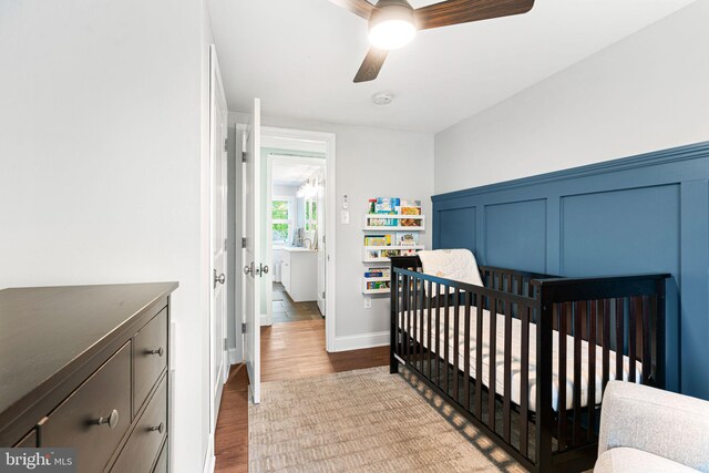 401 Woodland Ave, Glendora, NJ 08029 - bedroom with wood finished floors, a nursery area, and a ceiling fan