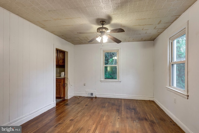 6109 Oakland Mills Rd, Sykesville, MD 21784 - unfurnished room featuring dark wood finished floors, plenty of natural light, a ceiling fan, baseboards, and an ornate ceiling
