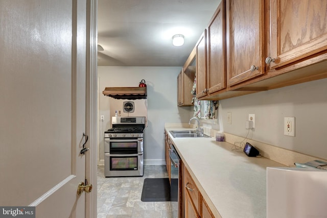 6109 Oakland Mills Rd, Sykesville, MD 21784 - kitchen featuring appliances with stainless steel finishes, a sink, brown cabinetry, light countertops, and baseboards