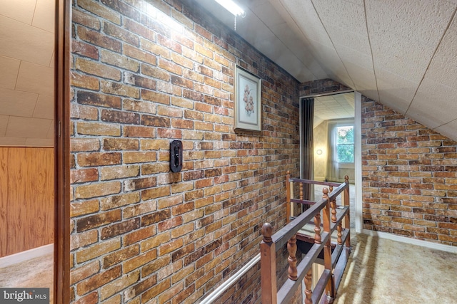 6109 Oakland Mills Rd, Sykesville, MD 21784 - corridor with an upstairs landing, brick wall, carpet flooring, lofted ceiling, and baseboards