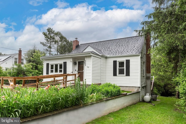 6109 Oakland Mills Rd, Sykesville, MD 21784 - bungalow-style home with a chimney, a wooden deck, roof with shingles, and a front lawn