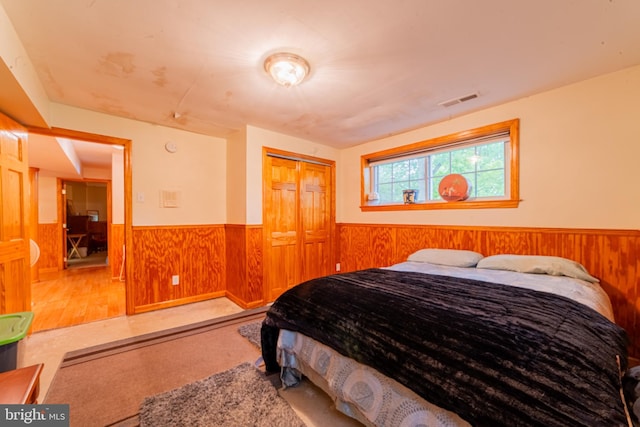 39 Holly Ln, Pilesgrove, NJ 08098 - bedroom featuring wainscoting, wooden walls, and a closet