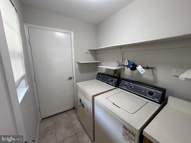 washroom with independent washer and dryer and light tile patterned floors