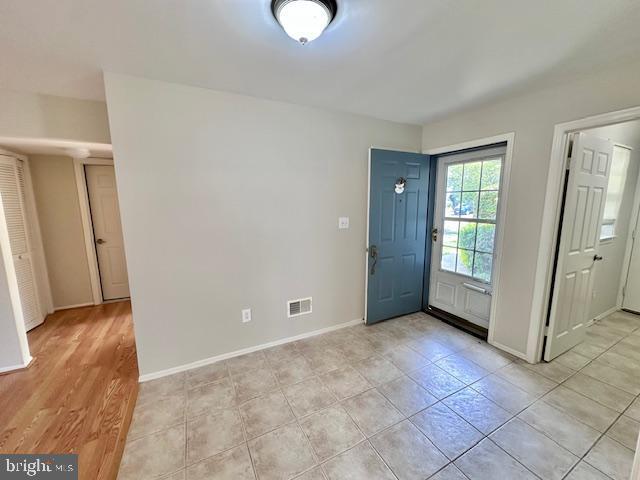 entrance foyer with baseboards and light tile patterned flooring