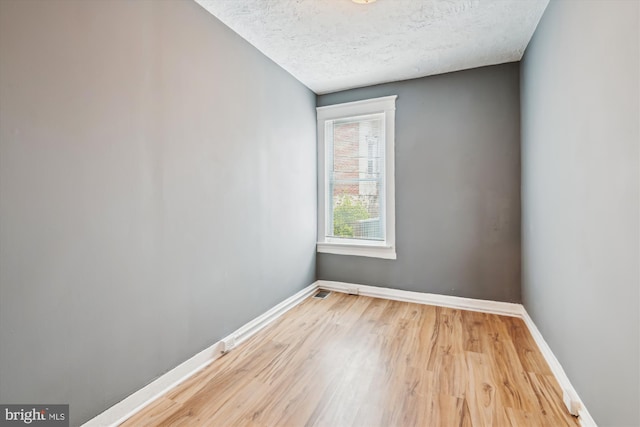 1081 Ellicott Dr, Baltimore, MD 21216 - spare room with baseboards, wood finished floors, and a textured ceiling