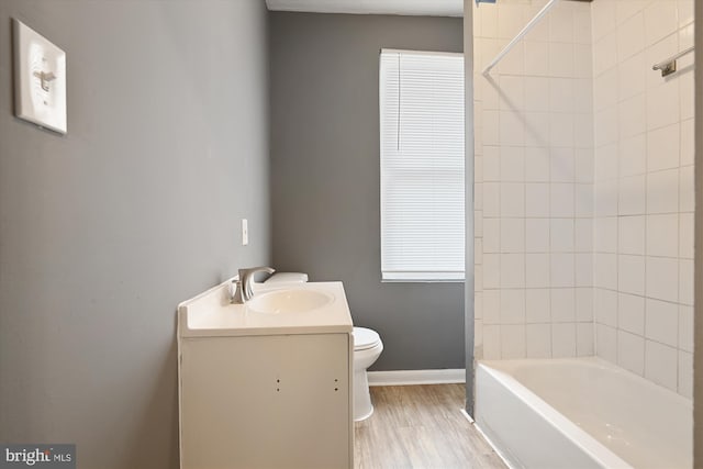 1081 Ellicott Dr, Baltimore, MD 21216 - full bathroom with toilet, wood finished floors, vanity, baseboards, and tub / shower combination