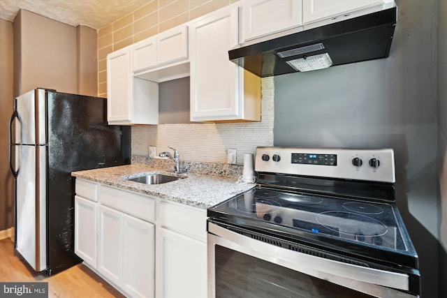 1081 Ellicott Dr, Baltimore, MD 21216 - kitchen featuring stainless steel appliances, under cabinet range hood, a sink, white cabinetry, and tasteful backsplash