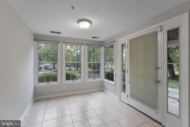 13113 Briarcliff Ter Unit 1-101, Germantown, MD 20874 - unfurnished sunroom featuring tile patterned floors, a textured ceiling, baseboards, and french doors