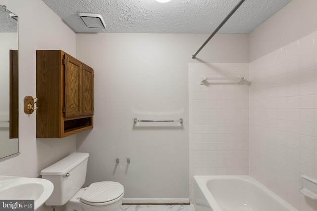13113 Briarcliff Ter Unit 1-101, Germantown, MD 20874 - full bathroom featuring toilet, a textured ceiling, marble look tiles, shower / bathtub combination, and a sink