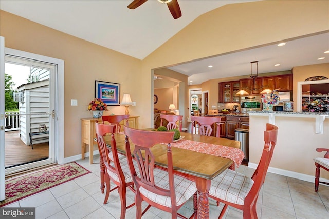 dining area featuring lofted ceiling, a ceiling fan, light tile patterned floors, recessed lighting, and baseboards