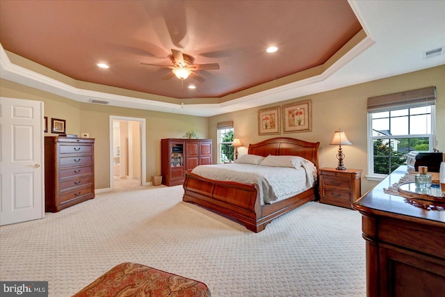 bedroom with a raised ceiling, light carpet, recessed lighting, baseboards, and a ceiling fan