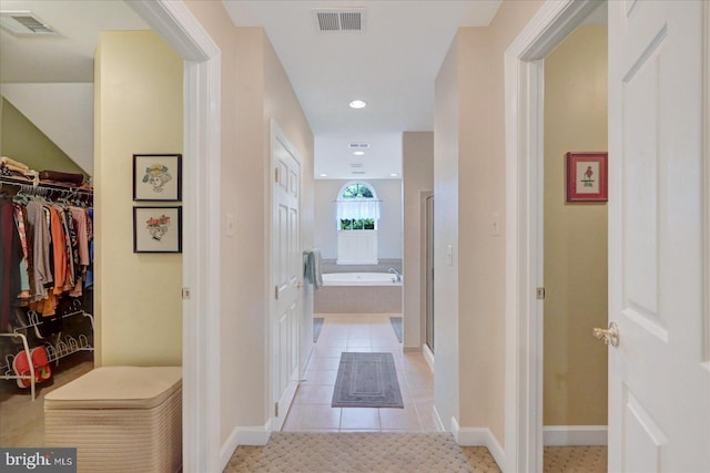 hall with light tile patterned floors, recessed lighting, and baseboards