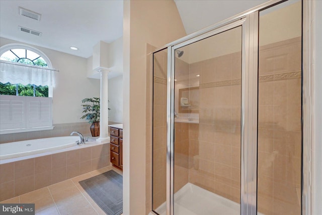 full bathroom featuring a garden tub, a stall shower, tile patterned floors, decorative columns, and vanity