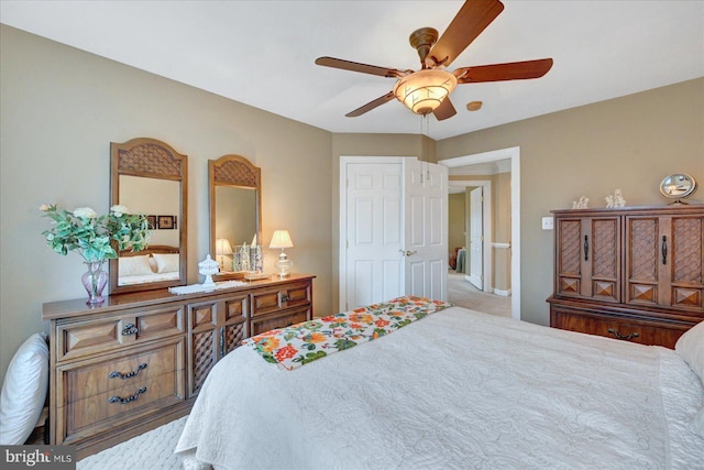 bedroom with a ceiling fan and baseboards