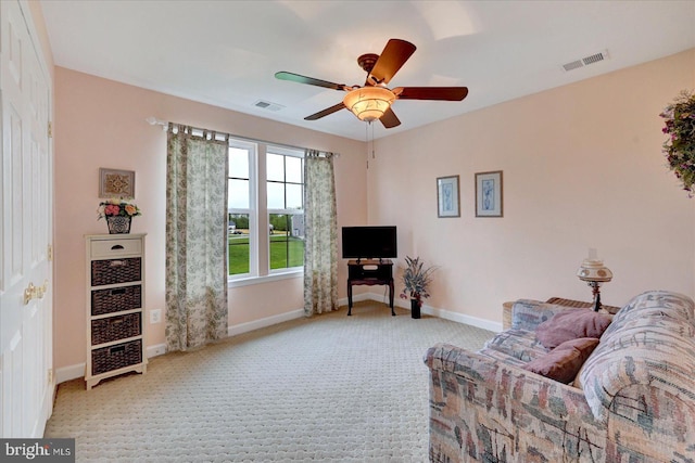 living room featuring carpet flooring, ceiling fan, and baseboards