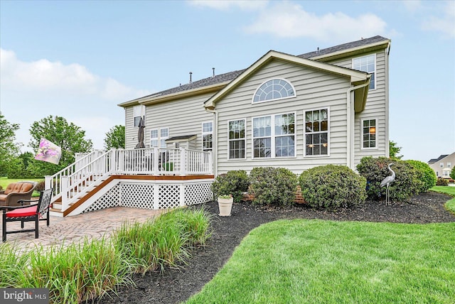 back of house with a wooden deck, a patio area, a yard, and stairs