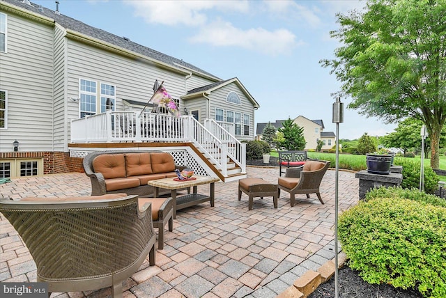 view of patio / terrace featuring an outdoor living space, a deck, and stairs