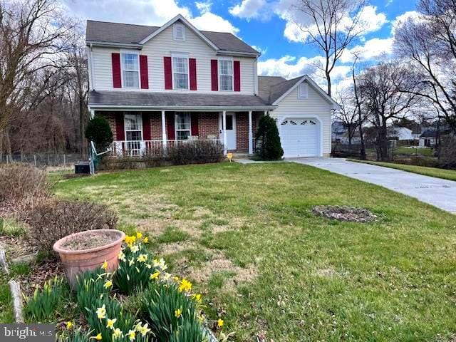 4001 Cedar Mills Rd, Randallstown, MD 21133 - view of front of property featuring covered porch, a garage, concrete driveway, a front yard, and brick siding
