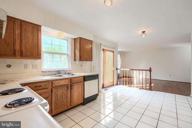 4001 Cedar Mills Rd, Randallstown, MD 21133 - kitchen with white appliances, a sink, brown cabinets, backsplash, and light countertops