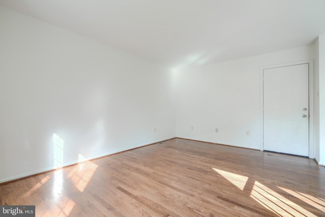 4001 Cedar Mills Rd, Randallstown, MD 21133 - empty room with wood finished floors and baseboards