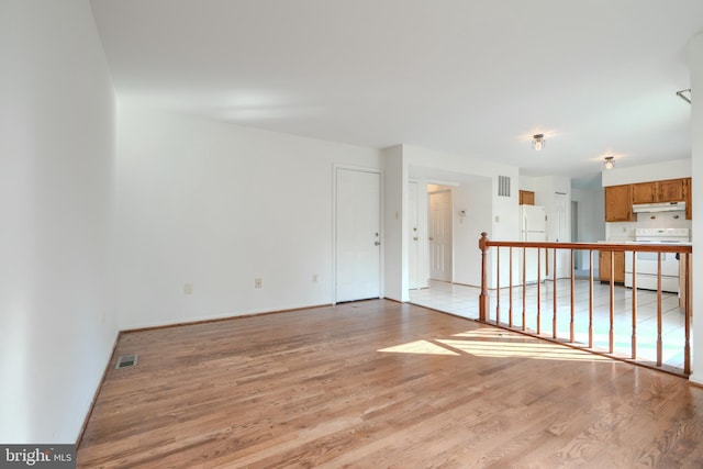 4001 Cedar Mills Rd, Randallstown, MD 21133 - unfurnished living room featuring light wood-type flooring and baseboards