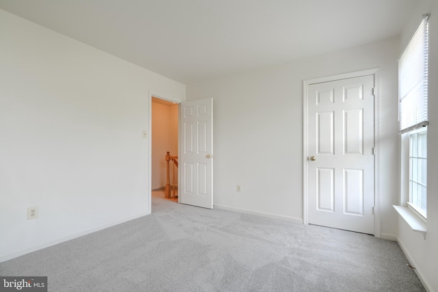 4001 Cedar Mills Rd, Randallstown, MD 21133 - unfurnished bedroom featuring carpet floors, multiple windows, and baseboards