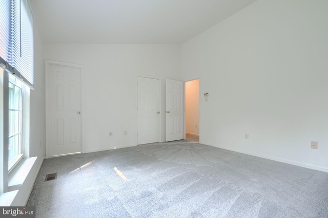 4001 Cedar Mills Rd, Randallstown, MD 21133 - empty room with carpet flooring, high vaulted ceiling, and baseboards