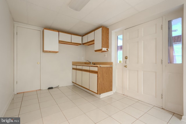 4001 Cedar Mills Rd, Randallstown, MD 21133 - kitchen with light countertops, plenty of natural light, a sink, and light tile patterned floors