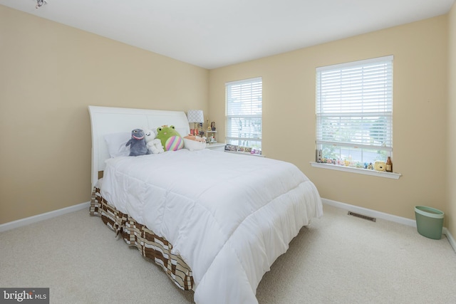 carpeted bedroom featuring baseboards