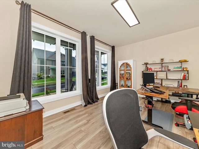 office space with wood finished floors and baseboards
