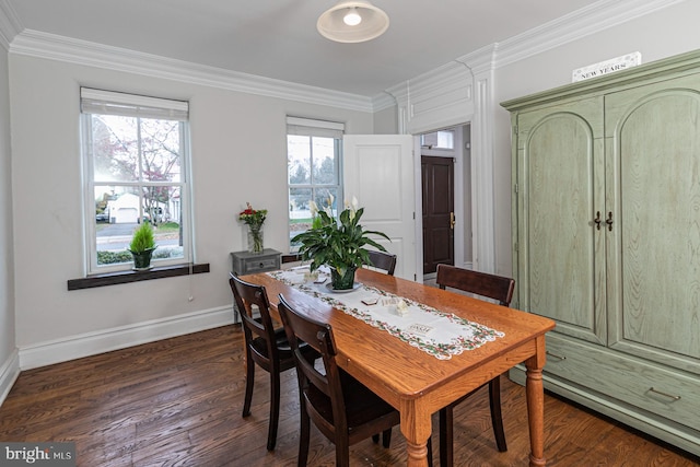 dining area with baseboards, crown molding, and dark wood finished floors