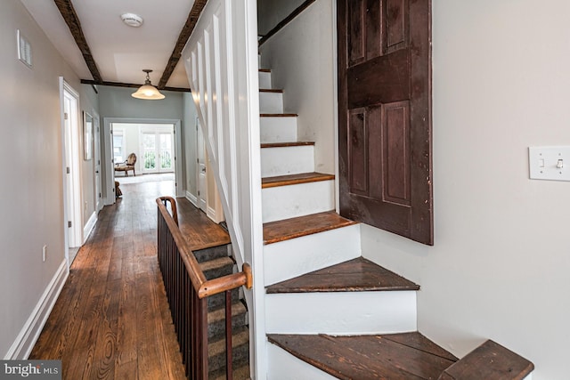 staircase featuring wood-type flooring and baseboards