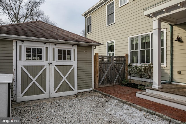 view of shed with fence and a gate
