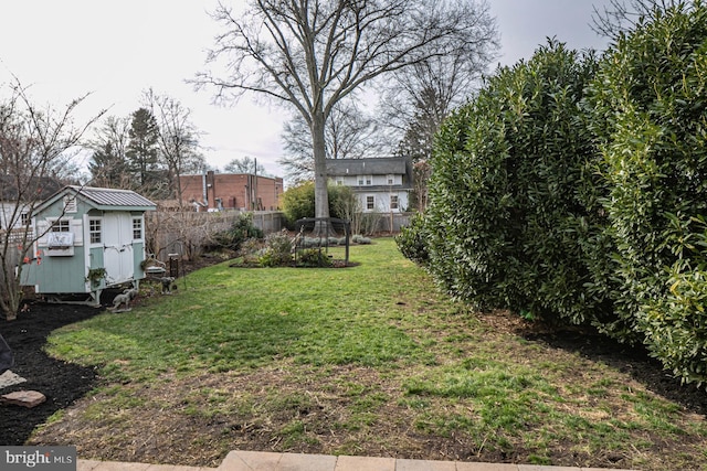 view of yard featuring a storage unit and an outbuilding