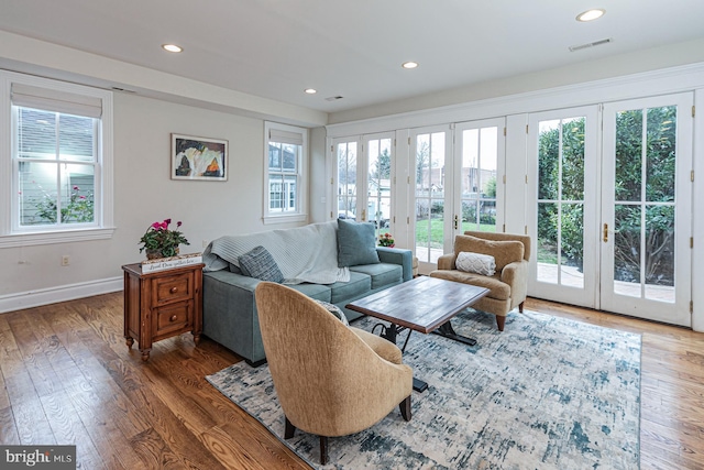 living area with french doors, wood finished floors, baseboards, and recessed lighting
