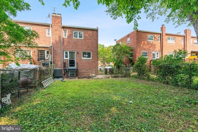 5817 Jamestown Rd, Hyattsville, MD 20782 - rear view of property with brick siding, a chimney, and cooling unit
