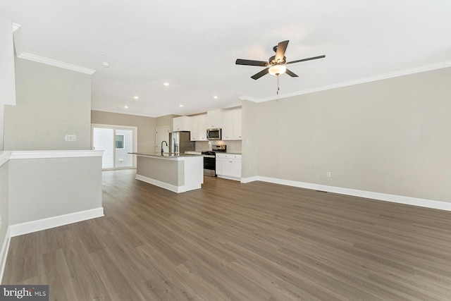 unfurnished living room with ceiling fan, baseboards, crown molding, wood finished floors, and recessed lighting