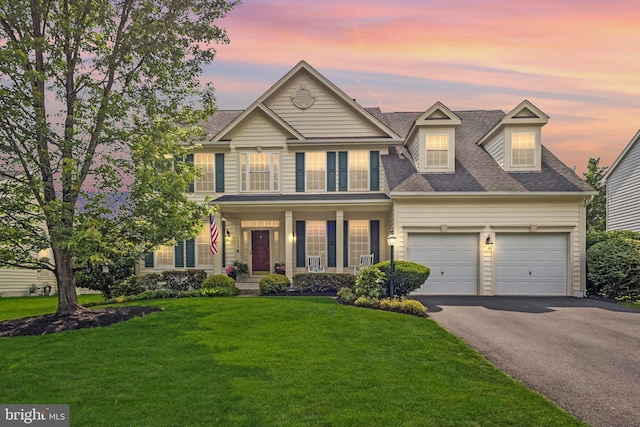 12649 Victory Lakes Loop, Bristow, VA 20136 - view of front of house featuring driveway, an attached garage, a front yard, a porch, and roof with shingles
