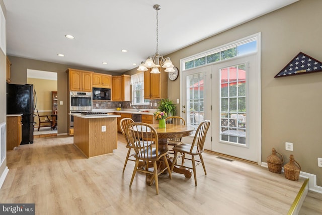 12649 Victory Lakes Loop, Bristow, VA 20136 - dining space with light wood-style flooring, a chandelier, healthy amount of natural light, and recessed lighting