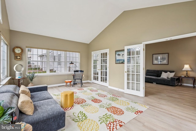 12649 Victory Lakes Loop, Bristow, VA 20136 - living room featuring french doors, high vaulted ceiling, and wood finished floors
