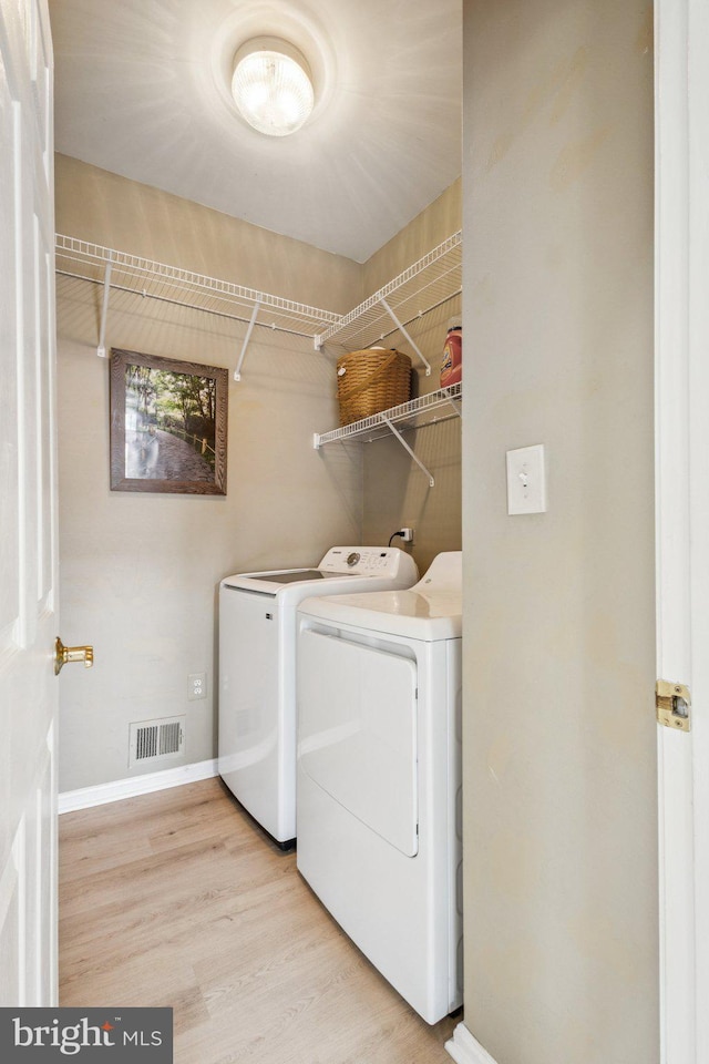 12649 Victory Lakes Loop, Bristow, VA 20136 - laundry area with washer and dryer and wood finished floors