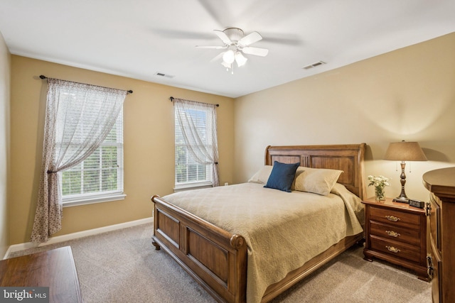 12649 Victory Lakes Loop, Bristow, VA 20136 - bedroom with multiple windows, light carpet, and a ceiling fan