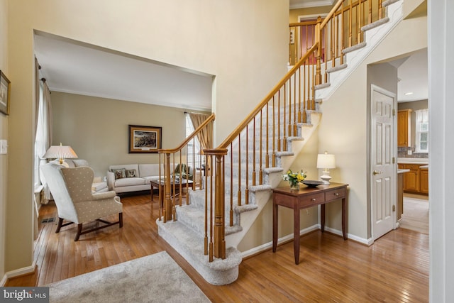 12649 Victory Lakes Loop, Bristow, VA 20136 - stairway featuring hardwood / wood-style flooring, a high ceiling, and crown molding