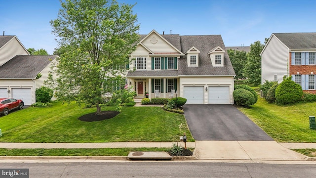 12649 Victory Lakes Loop, Bristow, VA 20136 - traditional-style house featuring driveway, a front yard, and an attached garage