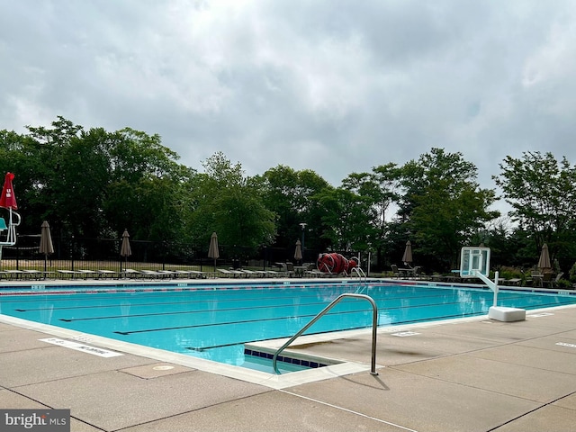 12649 Victory Lakes Loop, Bristow, VA 20136 - community pool with a patio and view of scattered trees