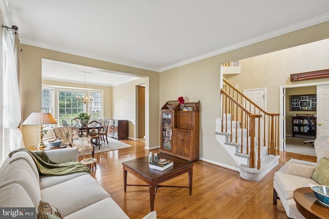12649 Victory Lakes Loop, Bristow, VA 20136 - living area featuring light wood-style flooring, stairway, ornamental molding, and a chandelier