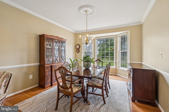 12649 Victory Lakes Loop, Bristow, VA 20136 - dining space featuring a chandelier, crown molding, and wood finished floors