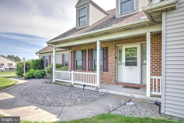 137 S Ronks Rd, Ronks, PA 17572 - doorway to property with a porch, brick siding, and roof with shingles