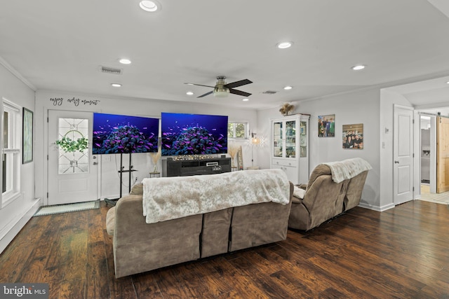 living room with a ceiling fan, recessed lighting, wood finished floors, ornamental molding, and baseboards