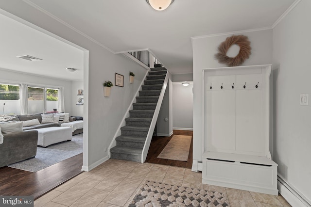 mudroom with a baseboard radiator, ornamental molding, and baseboards
